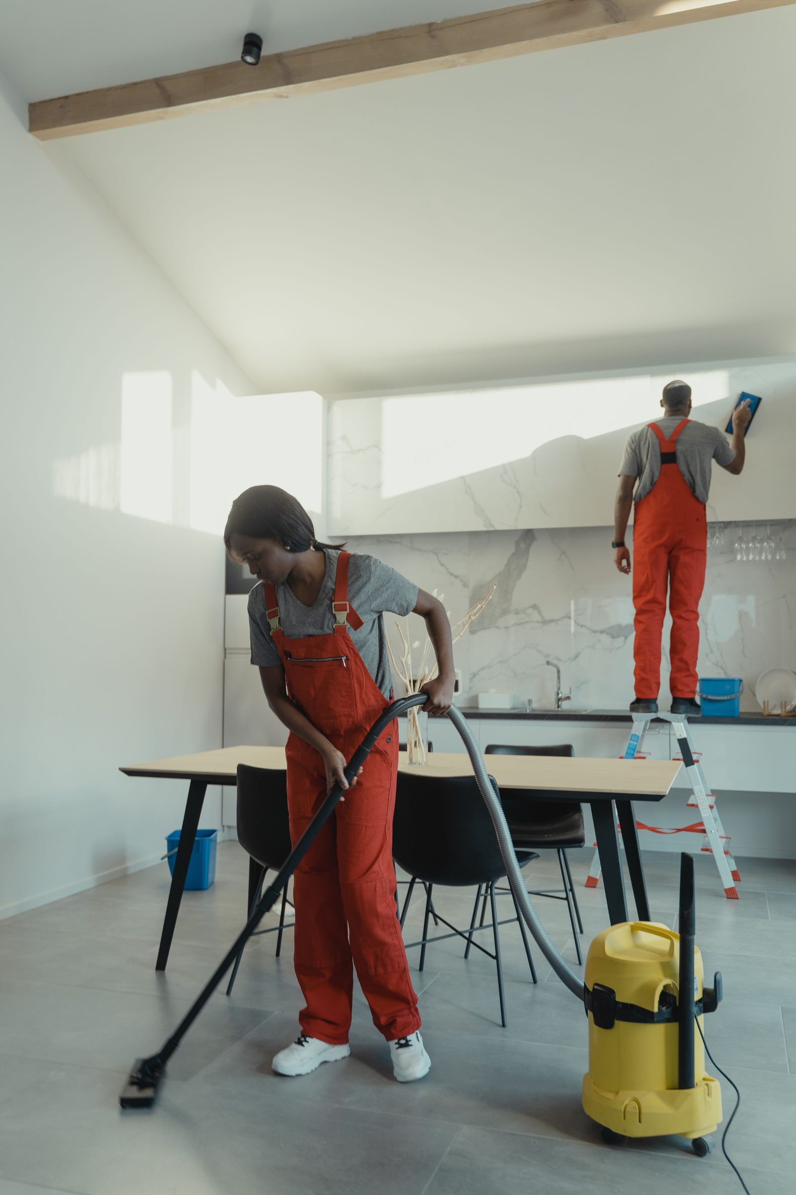 Professional cleaners working in a modern kitchen
