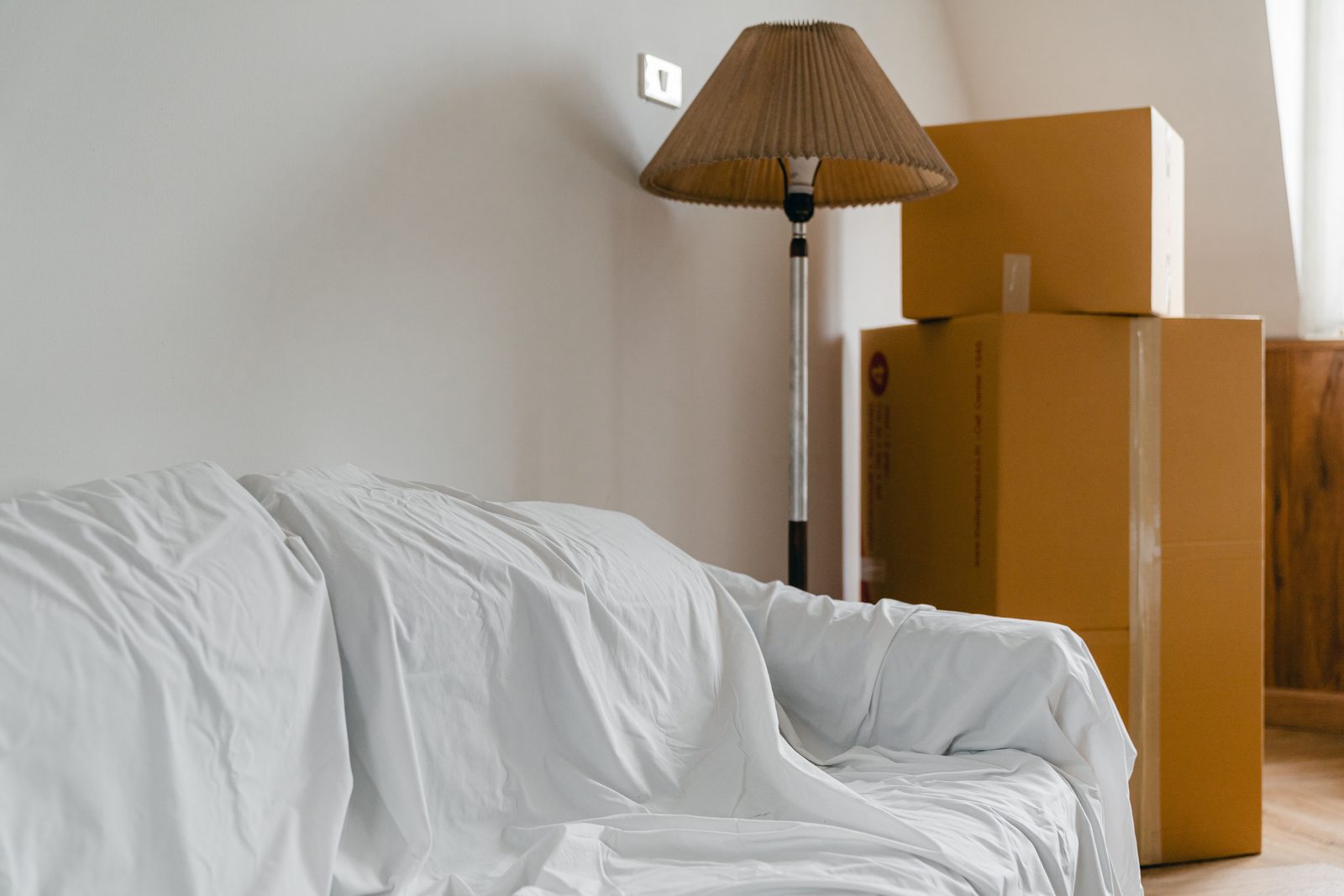Moving boxes in a bright home before move-in cleaning